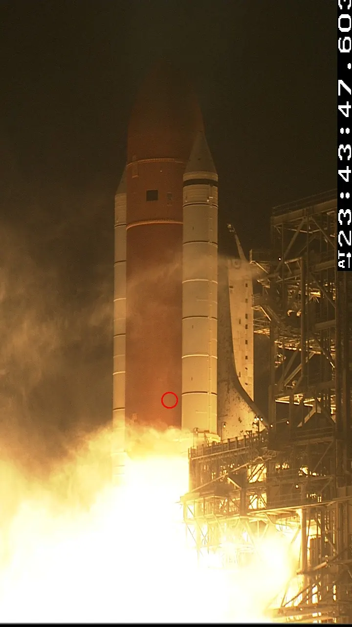 The bat still clinging as Discovery lifts off.